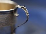 a silver cup that is sitting on a table