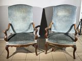 pair of blue upholstered chairs in a room with tile flooring