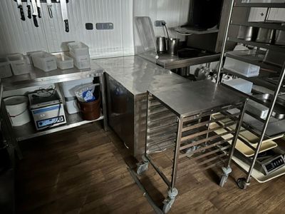 a large kitchen with a lot of stainless steel counter tops