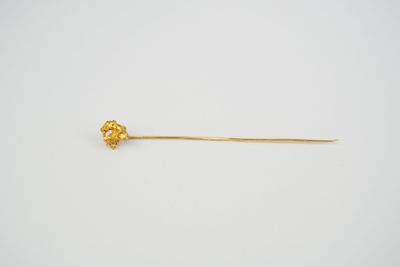 an image of a gold stick with a flower on it