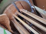 a box full of wooden utensils sitting on the floor