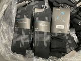 several pairs of men ' s black socks in a plastic bag