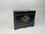 a black and gold chest sitting on top of a white table