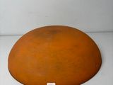 a large orange object sitting on a white surface
