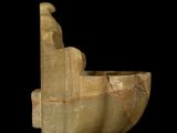 a sculpture of a man sitting in a boat on a black background