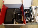 a box with a game controller and a charger inside of it