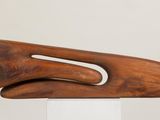 a sculpture of a wooden object on a white pedestal