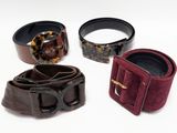 four pieces of leather and tortoises on a white surface
