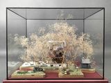 a display case with a lot of fake trees inside of it