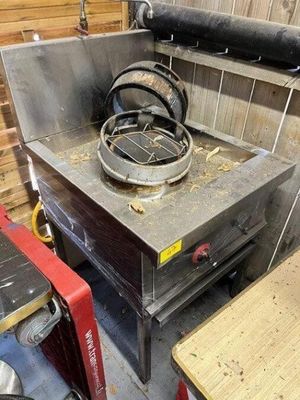 an image of a stove in a kitchen with a lot of wood