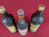 three bottles of wine that are sitting on a table