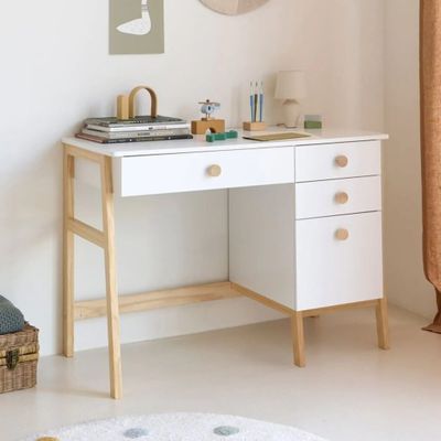 a white desk with a mirror above it in a room