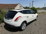 a white car that is parked on the side of the road