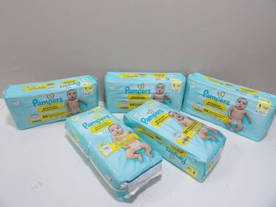 four packs of baby diapers sitting on top of a table