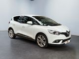 a white car in a white room with a black floor