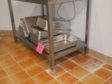 an image of a kitchen with a table and pots and pans on it