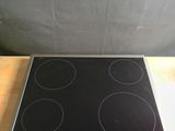 a black and silver stove top on a wooden table