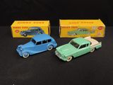 three toy cars are sitting next to each other on a black surface
