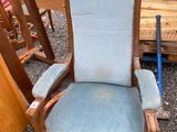 a blue chair with a baseball bat on it