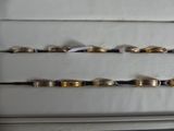 a lot of gold and silver rings on a shelf
