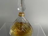 a clear glass bottle with a yellow liquid inside of it