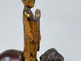 a statue of a man riding a horse with a dog