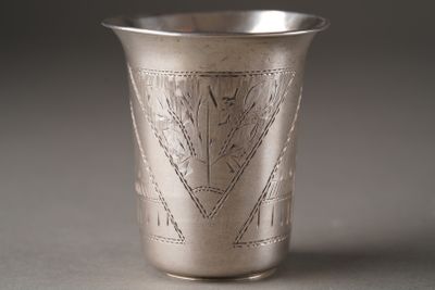 a silver cup that has a design on it