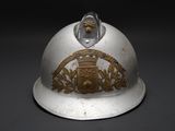 a silver helmet with a gold emblem on it