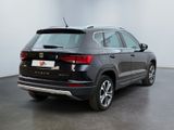 the rear end of a black volkswagen suv parked in a white room