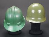 two hard hats sitting next to each other on a table