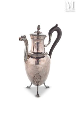 silver plated coffee pot with a black handle on a stand