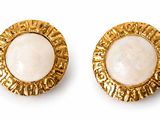 two pairs of gold tone earrings with a white stone in the center