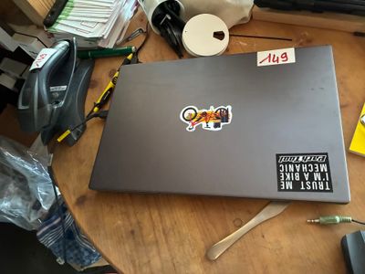 a laptop with stickers on it sitting on a table
