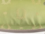 a close up of a chair with a green cushion