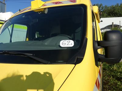 a yellow truck parked in a parking lot with a number on it