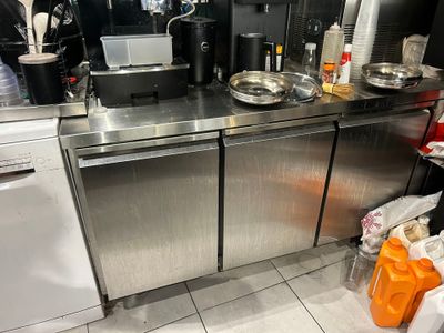 a stainless steel counter top with a dishwasher and a coffee maker