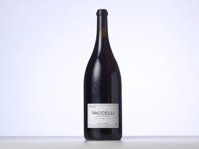 the bottle of wine is sitting on the table with a white background