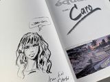 an open book with a drawing of a woman and a picture of a man