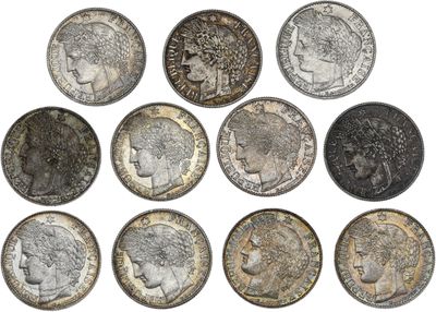 a close up of a bunch of coins on a white surface