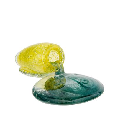 a yellow and green glass object sitting on top of a blue plate