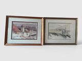 two framed pictures of buildings and a church on a snowy day