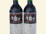 two bottles of wine sitting next to each other on a table