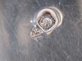 a close up view of a silver plate with a heart on it