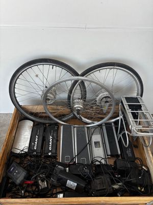 a wooden box filled with electronic equipment and a bicycle wheel