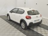 a picture of a white car parked in a garage