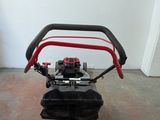 a small lawn mower sitting on the floor in a room