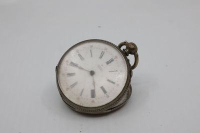 a small silver pocket watch with roman numerals on it