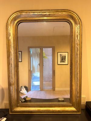a mirror that is sitting on a table in a room