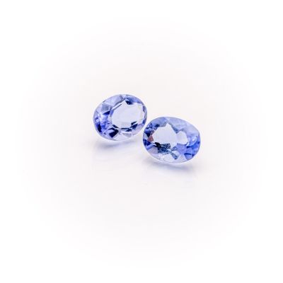 a pair of tanzane blue sapphires on a white background