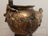 a bronze vase with a man riding a horse on it